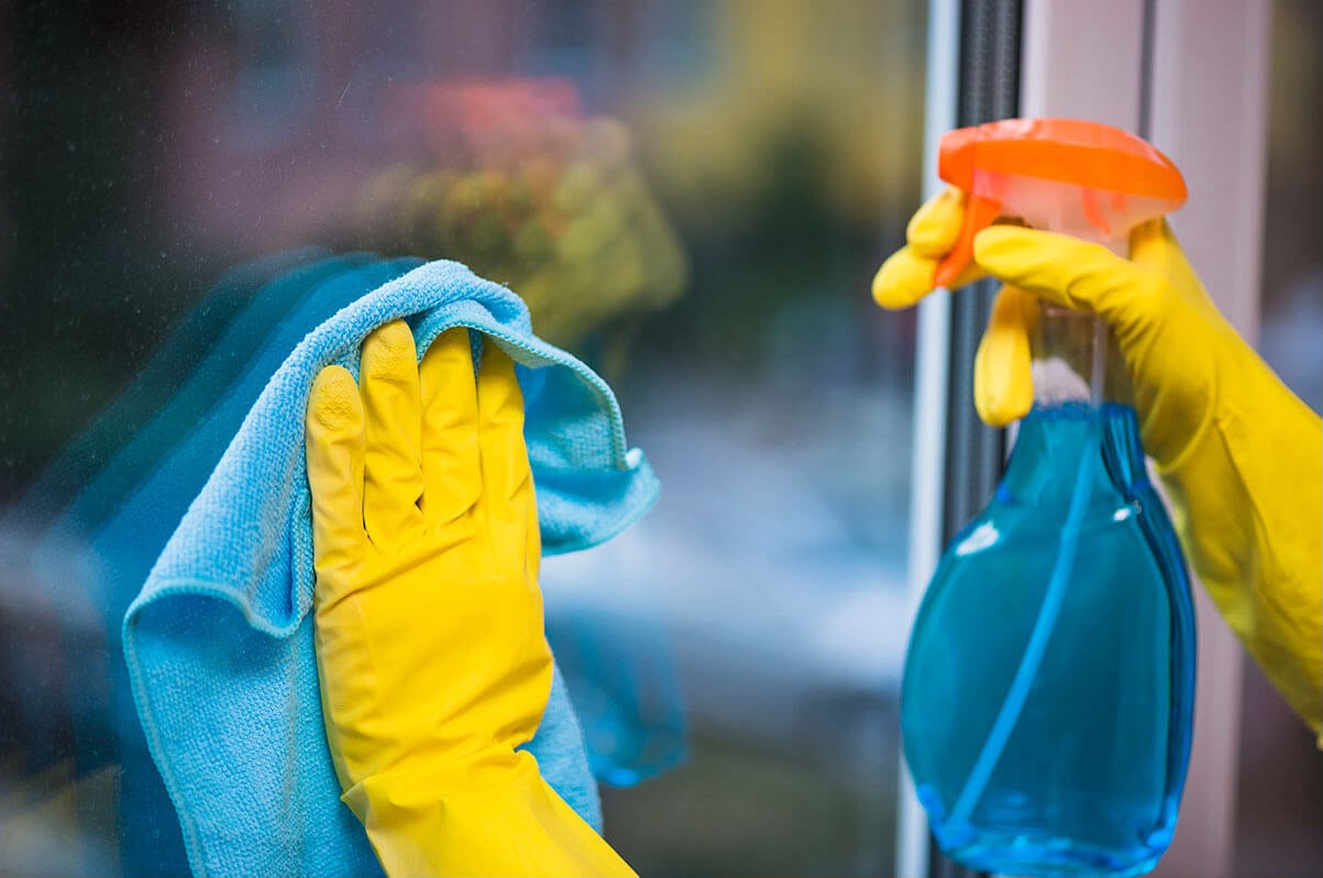 ALLSTAR Cleaning team member cleaning a window